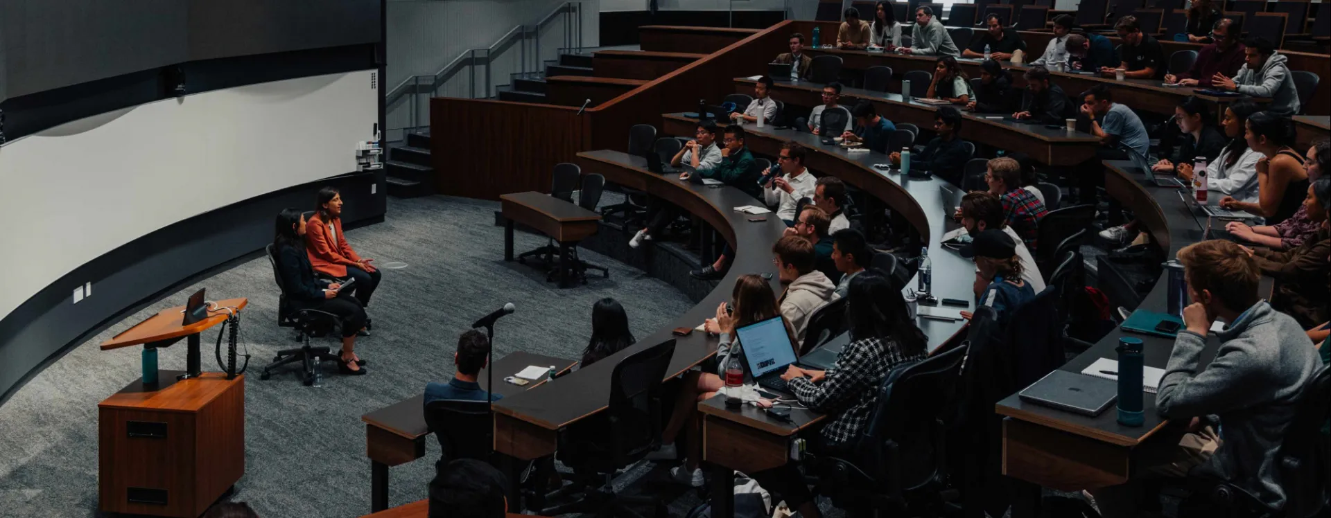 Lina Khan speaks in front of a lecture hall.